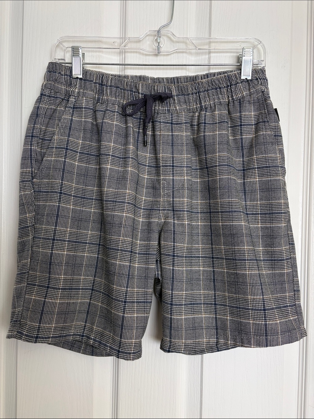 Colin’s -  Grey and Blue plaid shorts.  Two side, two back pockets.